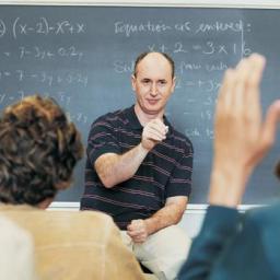 A teacher is teaching in front of a class of students.